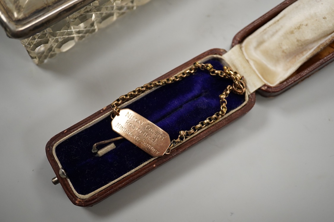 An early 20th century silver mounted cut glass scent bottle, five silver mounted glass toilet jars, a pair of silver mounted dwarf candlesticks, two silver condiments, a sterling jug(weighted), a sterling cup and cover(w